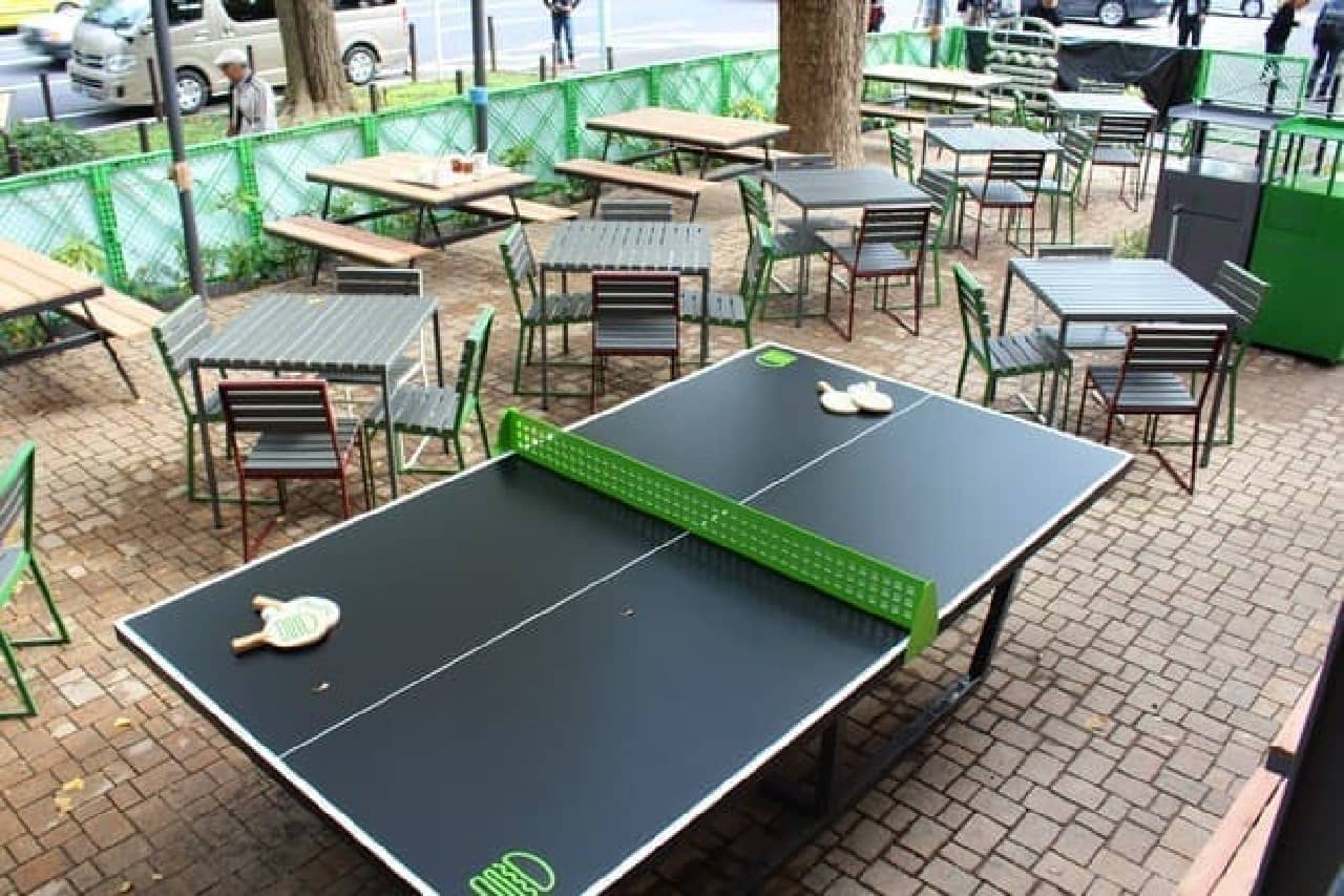 There is a table tennis table in one corner of the terrace seats