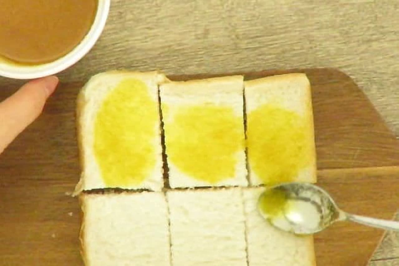 バターをを食パンの表面に塗るところ