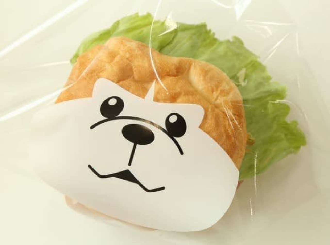 "Hachi DOG" is a hood with a tornado-shaped wiener in the buns of the beckoning bee face.