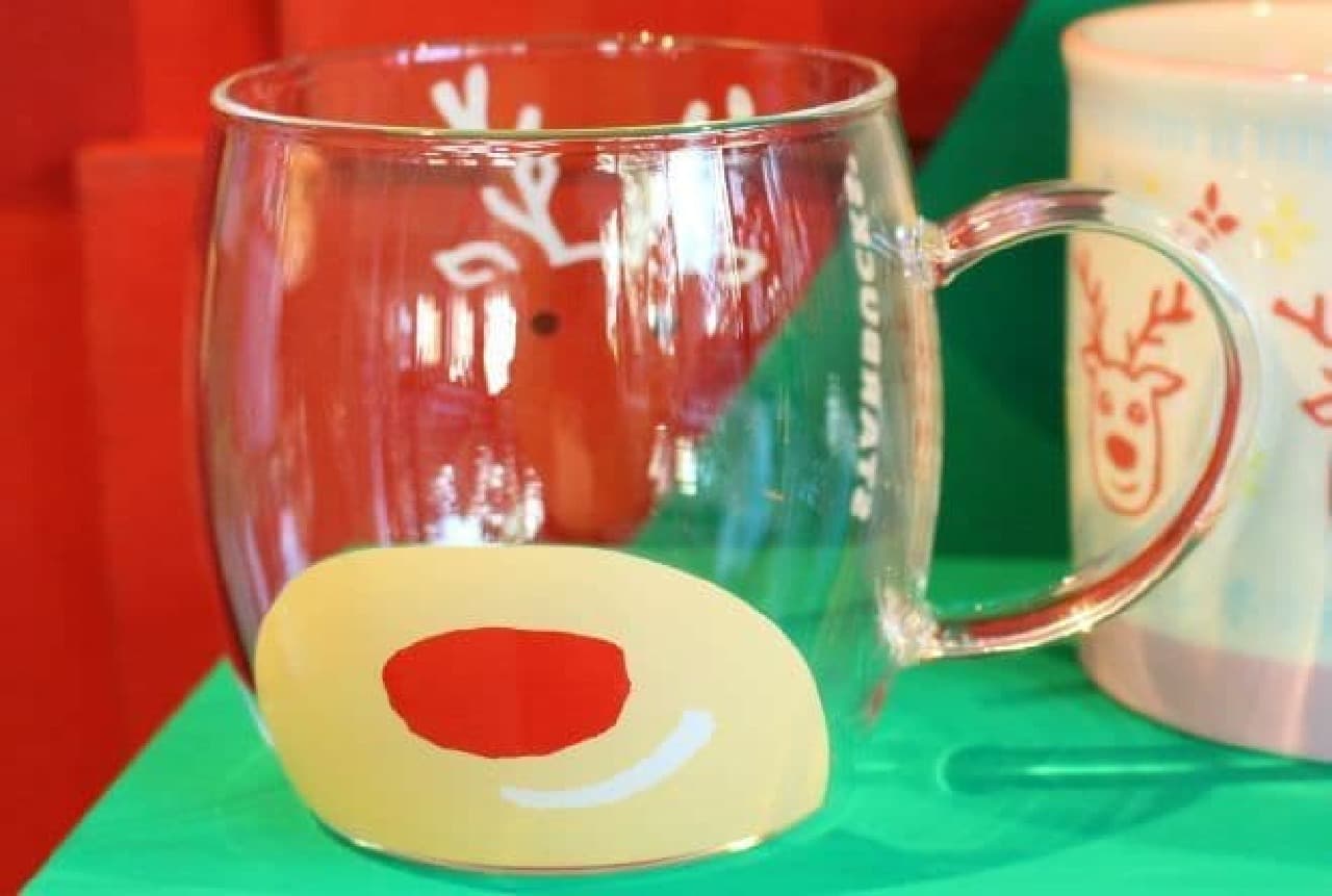 "Glass Mug Face 355ml" is a mug with a reindeer face printed on it.