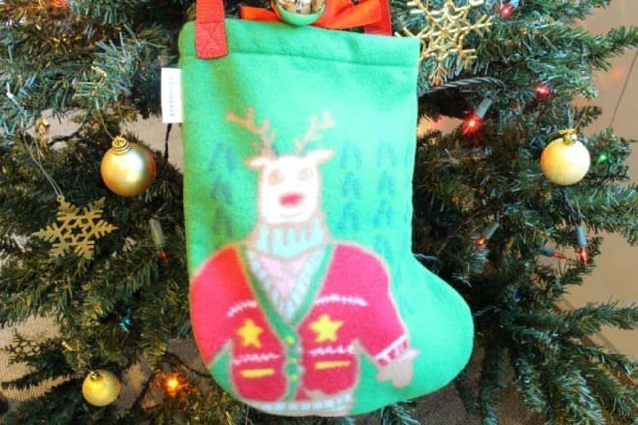 "Socks bag green" is a sock bag with a muscular reindeer drawn on it.