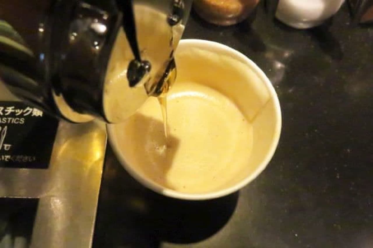 A cup of "Cappuccino" milk changed to almond milk (+50 yen) and honey added at the condition bar.