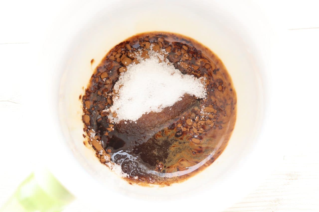 Instant coffee, sugar and hot water in a bowl