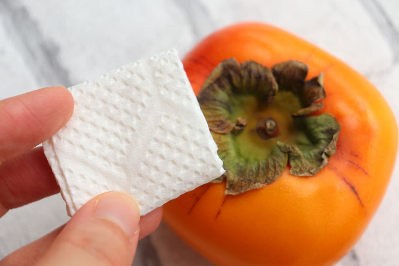 Step 1 Fold the kitchen paper or tissue to a size that covers the calyx of the persimmon.