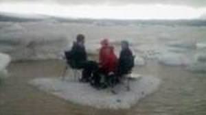 American tourists having a picnic on a glacial lake are swept off the table