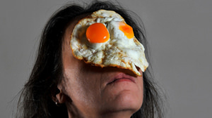 Art work "On Your Face" taken with raw meat, mandarin oranges, cream, fried egg, etc. on the face