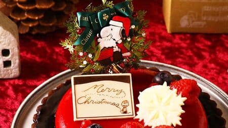 Snoopy's Christmas Cake, available for pre-order at PEANUTS Cafe online store Bright red glassage with berry topping for an elegant finish.