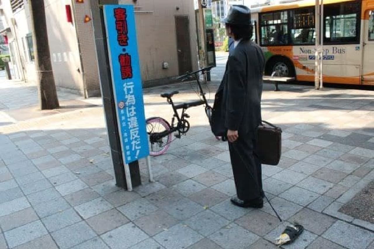 Mr. Naganuma standing in front of the signboard