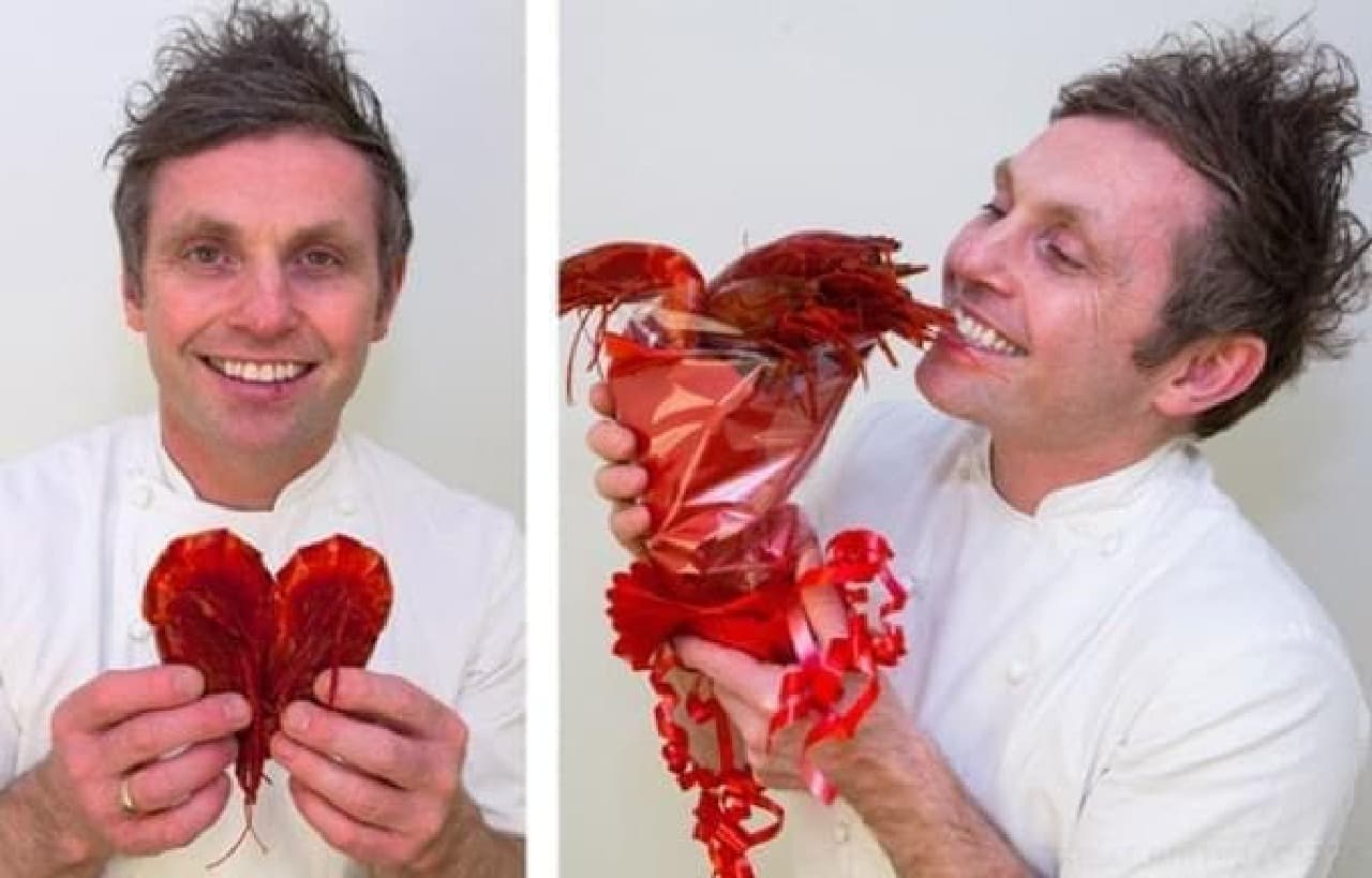 A chef with a smile that makes shrimp look like a heart