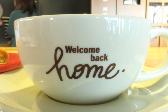 The word "Welcome back" on the side of the large mug